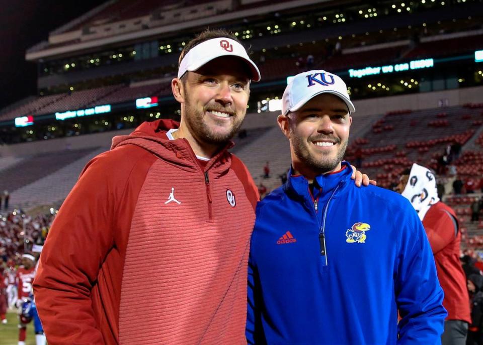 From Nov 17, 2018: Lincoln Riley (left), then Oklahoma Sooners head coach,g takes a photo with brother Garrett Riley, then an assistant with the Kansas Jayhawks, after their game at Oklahoma Memorial Stadium.