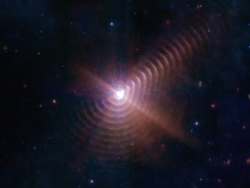 An image of finger-print like concentric circles of space dust formed when two stars in the Wolf-Rayet 140 binary pass each other.