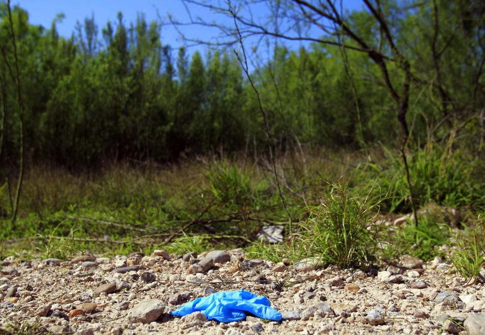 A forensic glove is located in the crime scene after a U.S. Border Patrol kidnapped and assaulted three immigrants from Honduras Thursday March 13, 2014, in Mission, Texas. Esteban Manzanares shot himself in the head killing himself before FBI agents entered his apartment. (AP Photo/The Monitor, Gabe Hernandez)