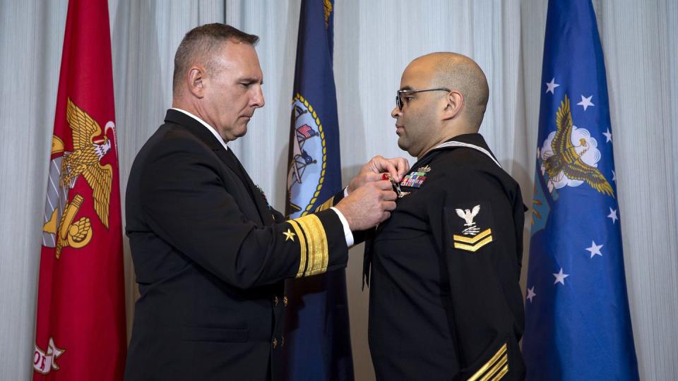 Information Systems Technician Second Class Thomas James, Defense Intelligence Agency, receives the Navy and Marine Corps Medal at a ceremony on Peterson Space Force Base, Colo., Oct. 5, 2023. ( Joshua Armstrong/Department of Defense)