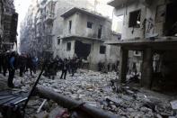 Residents inspect a damaged site after what activists said was an air strike from forces loyal to Syria's President Bashar al-Assad in Takeek Al-Bab area of Aleppo, December 15, 2013. REUTERS/Molhem Barakat