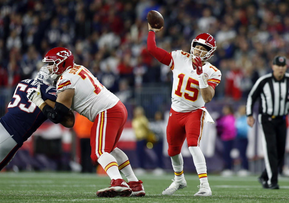 Kansas City Chiefs quarterback Patrick Mahomes (15) passes under pressure from New England Patriots linebacker Kyle Van Noy (53) during the first half of an NFL football game, Sunday, Oct. 14, 2018, in Foxborough, Mass. (AP Photo/Michael Dwyer)