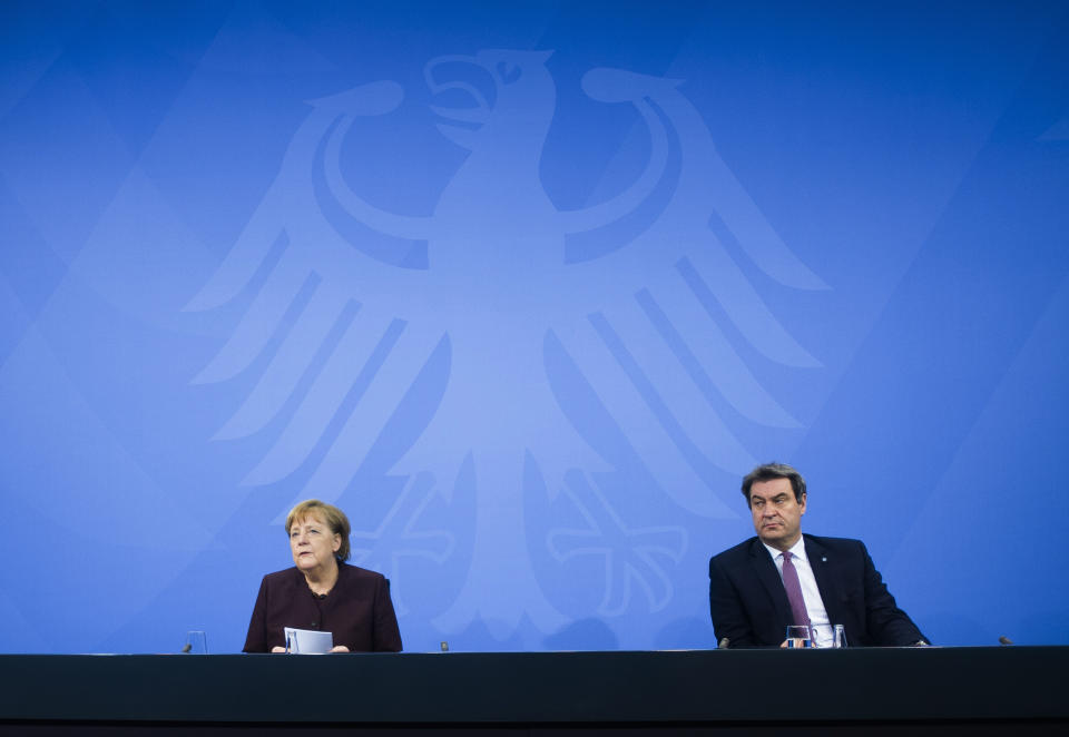 FILE - In this file photo dated Wednesday, Feb. 10, 2021, German Chancellor Angela Merkel, left, with Bavarian state governor Markus Soeder, during a news conference at the chancellery in Berlin, Germany. The 54-year-old Soeder is fighting to win enough backing across the political spectrum in hope of succeeding Angela Merkel as chancellor of Germany in Autumn 2021. (AP Photo/Markus Schreiber, FILE)
