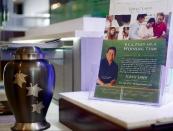 In this photo taken Thursday, Jan. 30, 2014, Mexican former Major League Baseball pitcher Fernando Valenzuela is pictured on the cover of a Forest Lawn promotional flyer at their stand at the Glendale Galleria mall in Glendale, Calif. Forest Lawn, famous as the final resting place for everyone from Al Jolson to Michael Jackson, has begun staffing outlets at shopping malls, reasoning that planning for death, either for a loved one or yourself, might not be quite as intimidating for some people if it takes place in a lively, happy place like a mall rather than the more somber confines of a cremation home. (AP Photo/Damian Dovarganes)