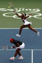 <p>Venus Williams of the United States returns a shot while playing with her sister Serena Williams against Virginia Ruano Pascual and Anabel Medina Garrigues of Spain in the Women’s Doubles gold medal match held at the Olympic Green Tennis Center during Day 9 of the Beijing 2008 Olympic Games on August 17, 2008 in Beijing, China. (Photo by Clive Rose/Getty Images) </p>