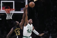 Boston Celtics center Al Horford (42) and Cleveland Cavaliers center Tristan Thompson (13) vie for a rebound during the first half of Game 1 of an NBA basketball second-round playoff series Tuesday, May 7, 2024, in Boston. (AP Photo/Charles Krupa)