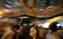 A dragon made of incense sticks is paraded during the Fire Dragon Dance performance through a Hong Kong street Saturday, Sept. 29, 2012. The Fire Dragon Dance is a spectacular celebration of local culture during the mid-autumn festival. (AP Photo/Kin Cheung)