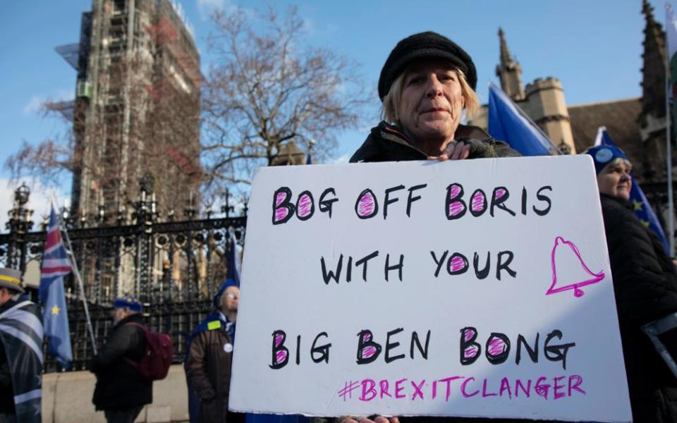 Anti Brexit protester with a placard reading 'Bog off Boris with your Big Ben bong' as a protest of the plan to potentially let Big Ben chime at midnight on January 31st. | Getty Images