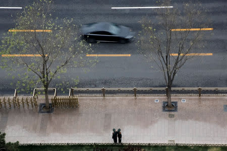 Paramilitary officers keep watch in Chang'an Avenue near Tiananmen Square in Beijing, China April 9, 2019. REUTERS/Thomas Peter