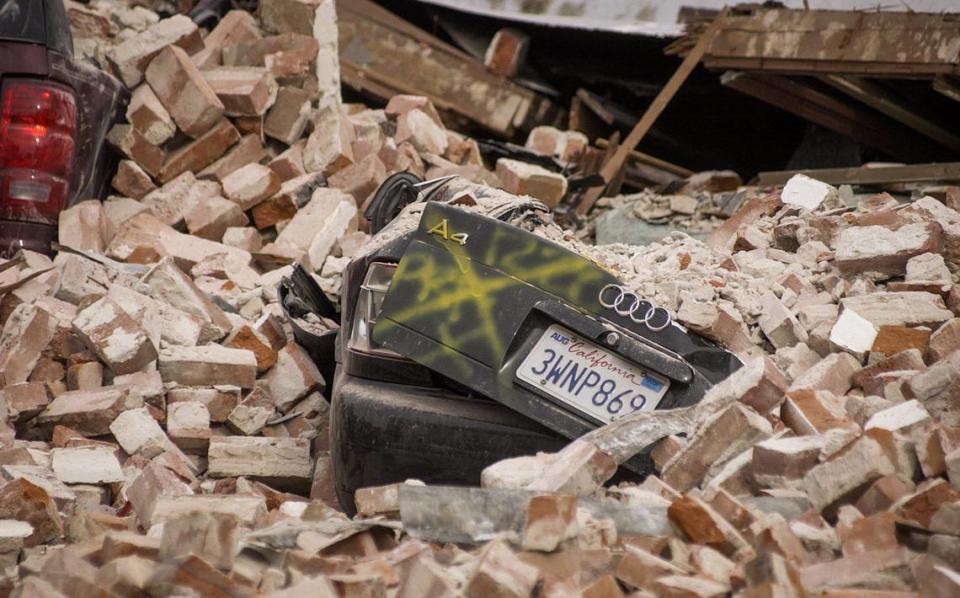 Cars were crushed on Pine Street in Paso Robles when an unreinforced masonry building collapsed during the San Simeon Earthquake on Dec. 22, 2003. Two people were killed in the quake.