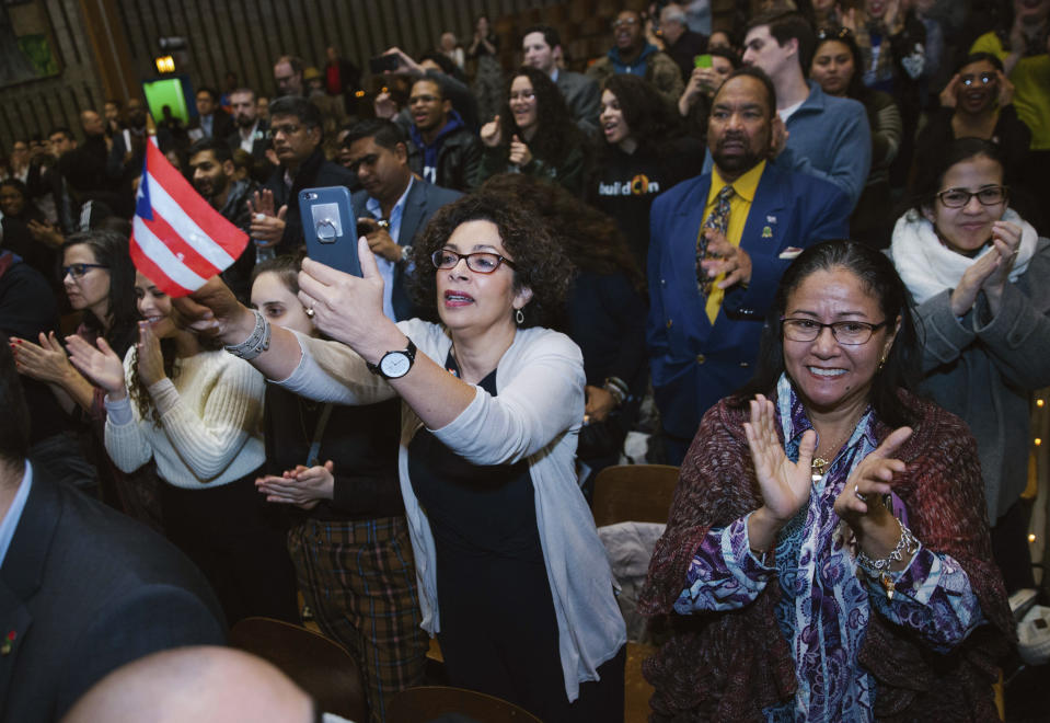 Supporters gave Congresswoman Alexandria Ocasio-Cortez a standing ovation following her inaugural address at the Renaissance School for Musical Theater and Technology in the Bronx borough of New York on Saturday, Feb. 16, 2019. (AP Photo/Kevin Hagen)