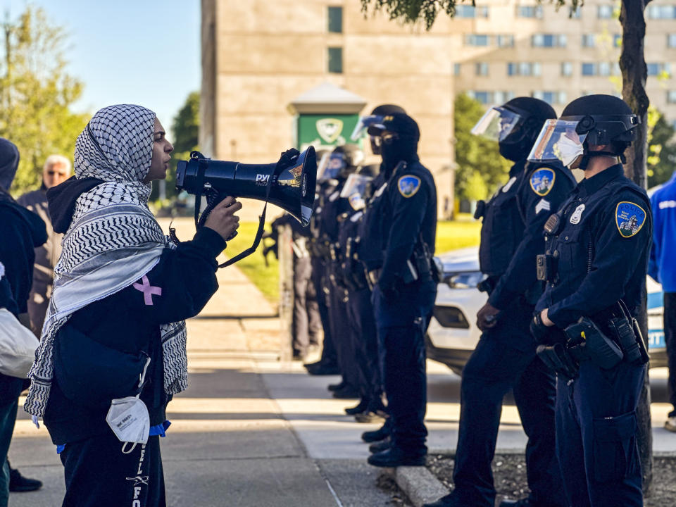 Protesters chant in front of a line of Wayne State police officers shortly after university authorities removed a pro-Palestinian encampment from campus on Thursday, May 30, 2024, in Detroit. (Marnie Munoz/Detroit News via AP)