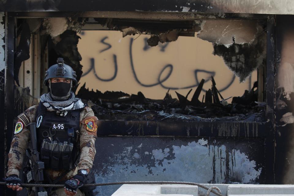 A member of Iraqi security forces stands guard during a protest to condemn air strikes on bases belonging to Hashd al-Shaabi (paramilitary forces), in Baghdad, Iraq January 1, 2020.