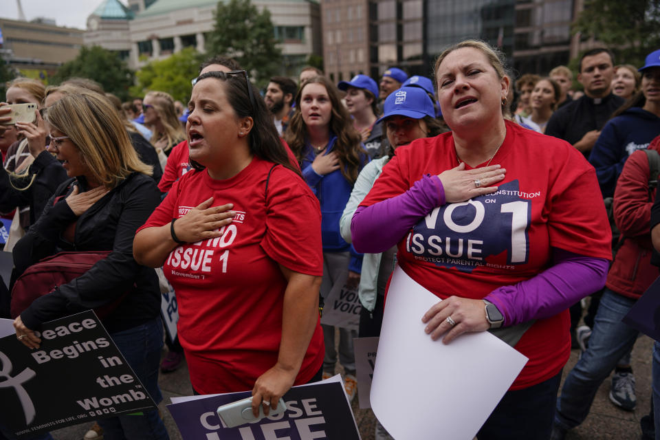 People gather and say the Pledge of Allegiance during the Ohio March for Life rally at the Ohio State House in Columbus, Ohio, Friday, Oct. 6, 2023. As campaigning escalates in Ohio’s fall fight over abortion rights, a new line of attack from opponents suggests “partial-birth” abortions would be revived if a proposed constitutional amendment passes. (AP Photo/Carolyn Kaster)