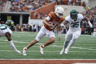Texas quarterback Quinn Ewers (3) runs past Baylor linebacker Jackie Marshall (35) for a touchdown during the first half of an NCAA college football game in Austin, Texas, Friday, Nov. 25, 2022. (AP Photo/Eric Gay)