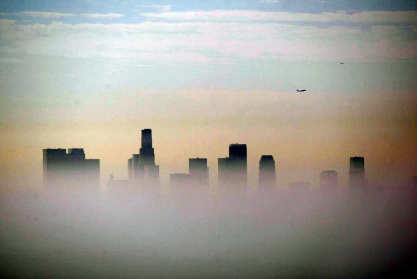 Genaro Molina ññ ñ 071049.ME.0923.smog2.GEM The downtown Los Angeles skyline peaks out above a layer of smog as seen from Griffith Park Tuesday morning.