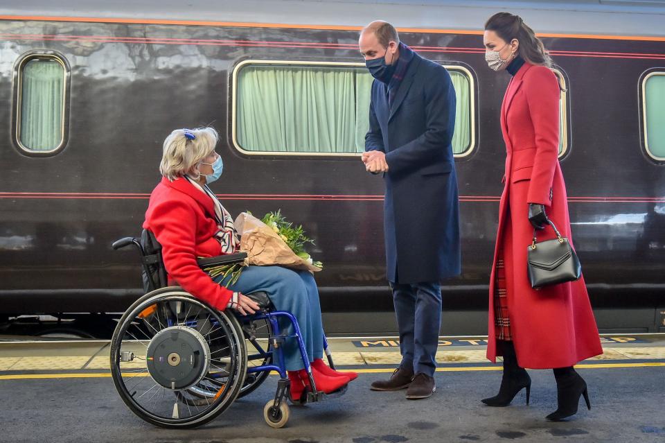 Britain's Prince William, Duke of Cambridge (C) and Britain's Catherine, Duchess of Cambridge (R) wearing protective face coverings to combat the spread of the coronavirus, are greeted by  Lord Lieutenant of Somerset, Annie Maw (L), as they arrive at Bath Spa station in Bath, in south west England, for a visit to Cleve Court Care Home to pay tribute to the efforts of care home staff throughout the COVID-19 pandemic, on December 8, 2020, on the final day of engagements on their tour of the UK. - During their trip, their Royal Highnesses hope to pay tribute to individuals, organisations and initiatives across the country that have gone above and beyond to support their local communities this year. (Photo by Ben Birchall / POOL / AFP) (Photo by BEN BIRCHALL/POOL/AFP via Getty Images)