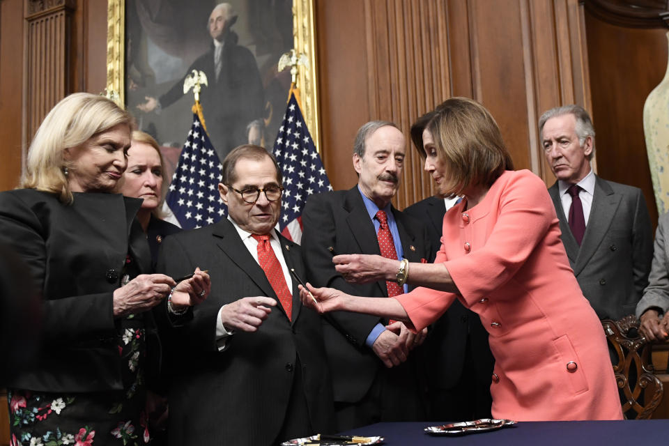 House Speaker Nancy Pelosi of Calif., second from right, gives pens to, from left, House Oversight and Government Reform Committee Chair Rep. Carolyn Maloney, D-N.Y., Rep. Sylvia Garcia, D-Texas, House Judiciary Committee Chairman Rep. Jerrold Nadler, D-N.Y., House Foreign Affairs Committee Chairman Rep. Eliot Engel, D-N.Y., and House Ways and Means Committee Chairman Rep. Richard Neal, D-Mass., after she signed the resolution to transmit the two articles of impeachment against President Donald Trump to the Senate for trial on Capitol Hill in Washington, Wednesday, Jan. 15, 2020. The two articles of impeachment against Trump are for abuse of power and obstruction of Congress. (AP Photo/Susan Walsh)