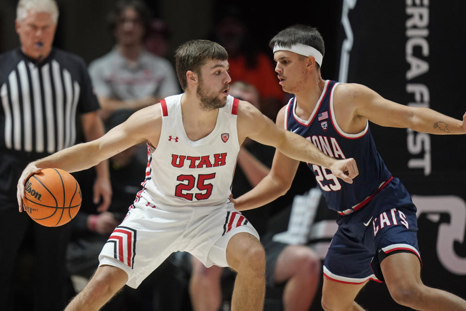 Arizona guard Kerr Kriisa (25) defends against Utah guard Rollie Worster (25) during the first half of an NCAA college basketball game Thursday, Dec. 1, 2022, in Salt Lake City. (AP Photo/Rick Bowmer)