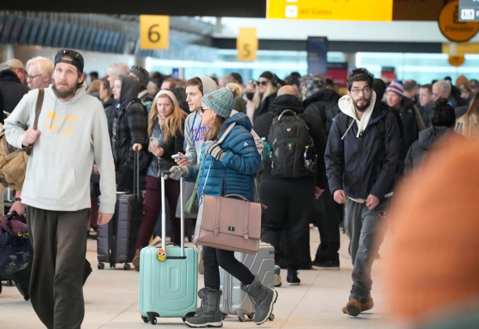 Travelers queue up to check in at the Southwest Airlines counter in Denver International Airport after a winter storm swept over the country packing snow combined with Arctic cold, which created chaos for people trying to reach their destinations before the Christmas holiday, Friday, Dec. 23, 2022, in Denver.