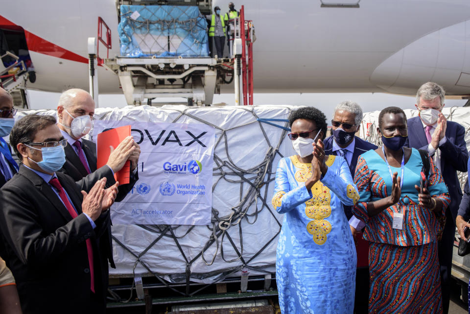 FILE - In this Friday, March 5, 2021 file photo, Uganda's Minister of Health Dr. Jane Ruth Aceng, center right, and other officials greet the country's first consignment of AstraZeneca COVID-19 vaccine manufactured by the Serum Institute of India and provided through the global COVAX initiative, at the airport in Entebbe, Uganda. Some Africans are hesitating to get COVID-19 vaccines amid concerns about their safety, alarming public health officials as some countries start to destroy thousands of doses that expired before use. (AP Photo/Nicholas Bamulanzeki, File)