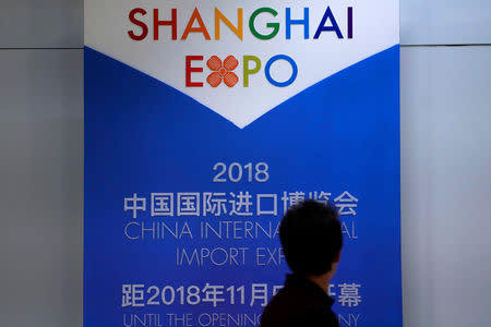 A man walks past a countdown board of the China International Import Expo in Shanghai, China June 29, 2018. REUTERS/Aly Song