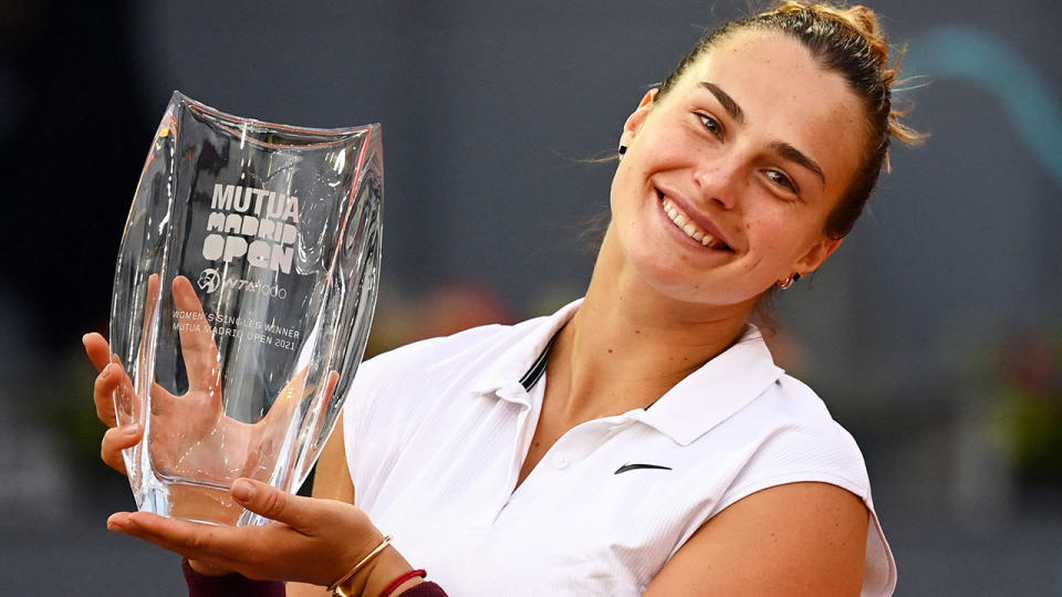 Pictured here, Aryna Sabalenka holds the Madrid Open trophy after winning the final against Ash Barty.