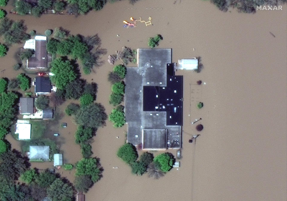 This photo provided by Maxar Technologies shows Windover High School surrounded by floodwaters in Midland, Mich., Wednesday, May 20, 2020. (Maxar Technologies via AP)