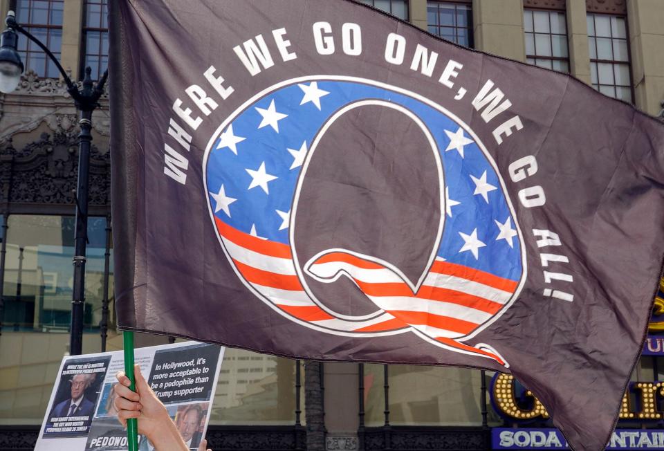 In this file photo taken on August 22, 2020, QAnon demonstrators protest in Los Angeles. An US father charged with killing his two children with a spear fishing gun claims he was 