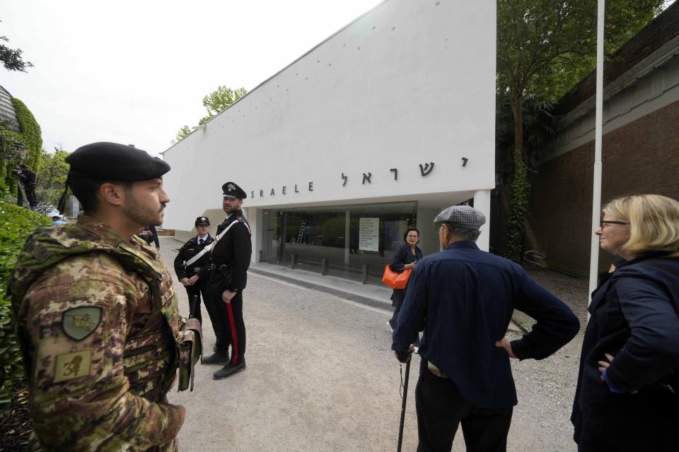 Italian Carabinieri paramilitary police and an Italian soldier patrol the Israeli national pavilion at the Biennale contemporary art fair in Venice, Italy, Tuesday, April 16, 2024. The artist and curators representing Israel at this year's Venice Biennale have announced Tuesday they won't open the Israeli pavilion until there is a cease-fire in Gaza and an agreement to release hostages taken Oct. 7.(AP Photo/Luca Bruno)