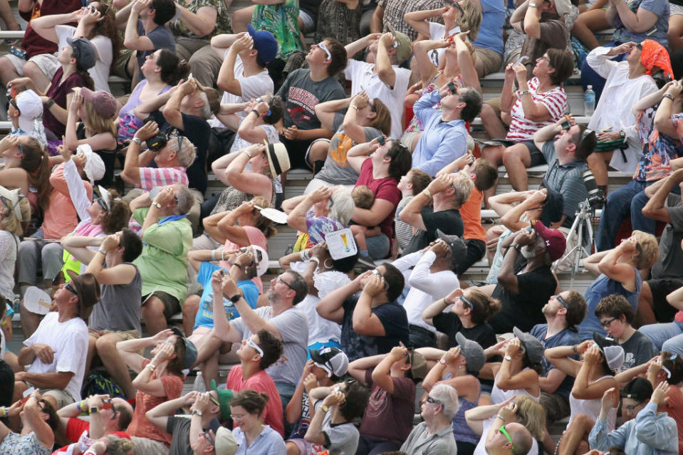 People watch the solar eclipse at Saluki Stadium on the campus of Southern Illinois University on August 21, 2017 in Carbondale, Illinois.