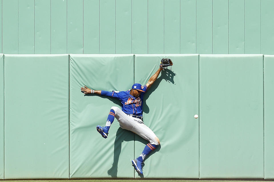 Keon Broxton of the New York Mets crashes into the wall as he attempts to catch a fly ball in the sixth inning of a Grapefruit League spring training game against the Boston Red Sox in Fort Myers, Florida, on March 9, 2019. (Photo: Michael Reaves via Getty Images)