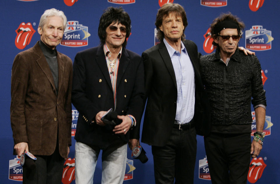 FILE - Members of the Rolling Stones, from left, drummer Charlie Watts, guitarist Ron Wood, singer Mick Jagger, and guitarist Keith Richards. pose for photographers after arriving for a Super Bowl news conference in Detroit on Feb. 2, 2006. Watts' publicist, Bernard Doherty, said Watts passed away peacefully in a London hospital surrounded by his family on Tuesday, Aug. 24, 2021. He was 80. The Rolling Stones were the halftime entertainment at Super Bowl XL foorball game between Pittsburgh Steelers and the Seattle Seahawks. (AP Photo/Michael Conroy, File)