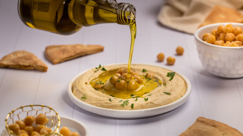 Olive oil poured over hummus