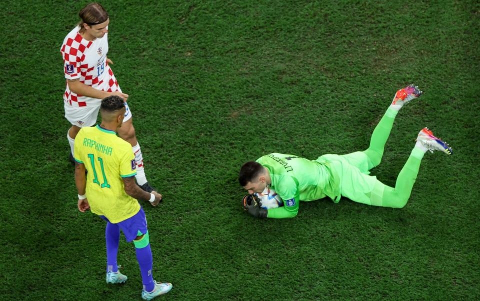 Croatia's goalkeeper #01 Dominik Livakovic secures the ball during the Qatar 2022 World Cup quarter-final football match between Croatia and Brazil - GIUSEPPE CACACE/AFP via Getty Images