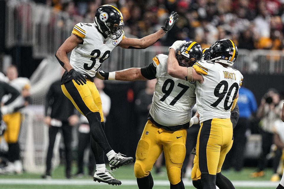 Pittsburgh Steelers safety Minkah Fitzpatrick (39) defensive tackle Cameron Heyward (97) and linebacker T.J. Watt (90) celebrate the sacking of Atlanta Falcons quarterback Marcus Mariota during the first half of an NFL football game, Sunday, Dec. 4, 2022, in Atlanta. (AP Photo/Brynn Anderson)