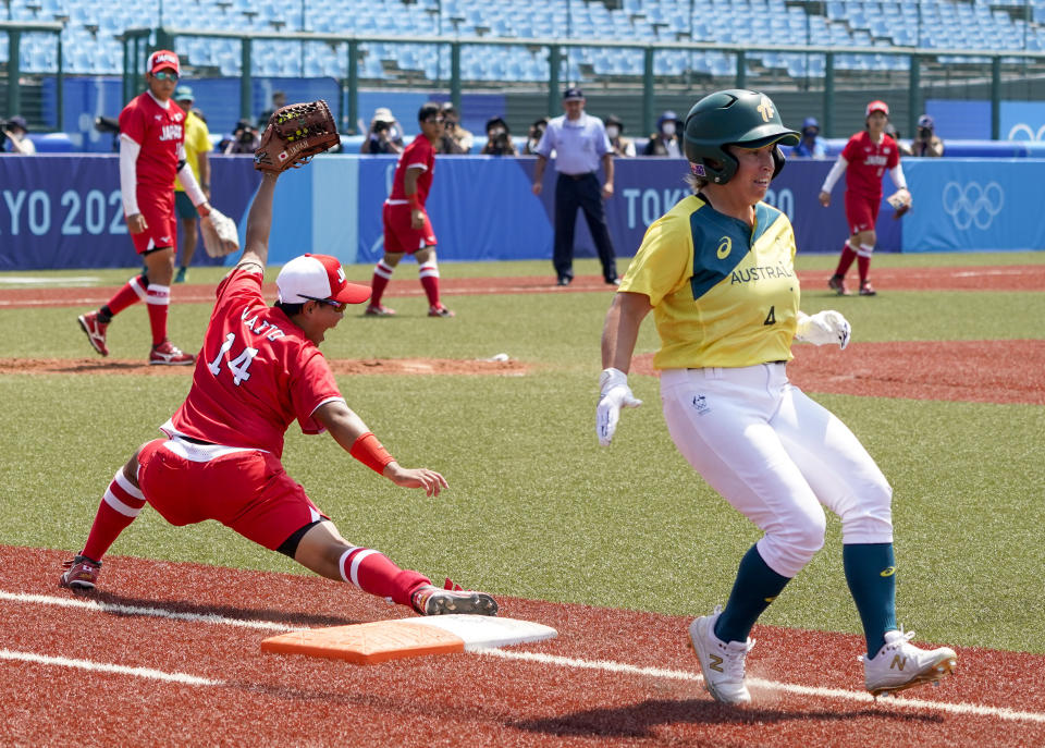 Japan's Minori Naito, left, reacts after getting Australia's Stacey McManus out during the softball game between Japan and Australia at the 2020 Summer Olympics, Wednesday, July 21, 2021, in Fukushima , Japan. (AP Photo/Jae C. Hong)