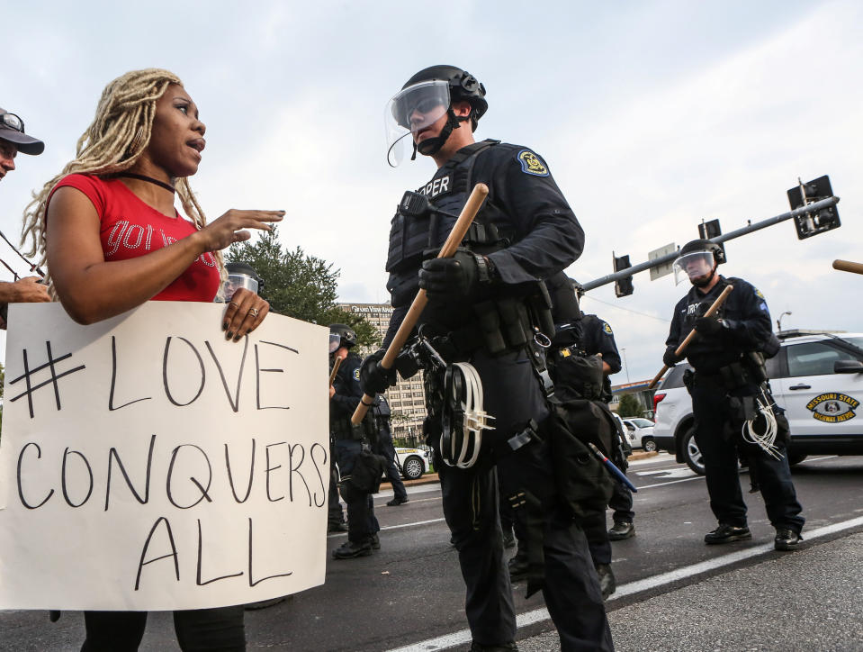 <p>A woman says a prayer next to a police officer during protests after the not guilty verdict in the murder trial of Jason Stockley, a former St. Louis police officer charged with the 2011 shooting of Anthony Lamar Smith, in St. Louis, Mo., Sept. 17, 2017. (Photo: Lawrence Bryant/Reuters) </p>
