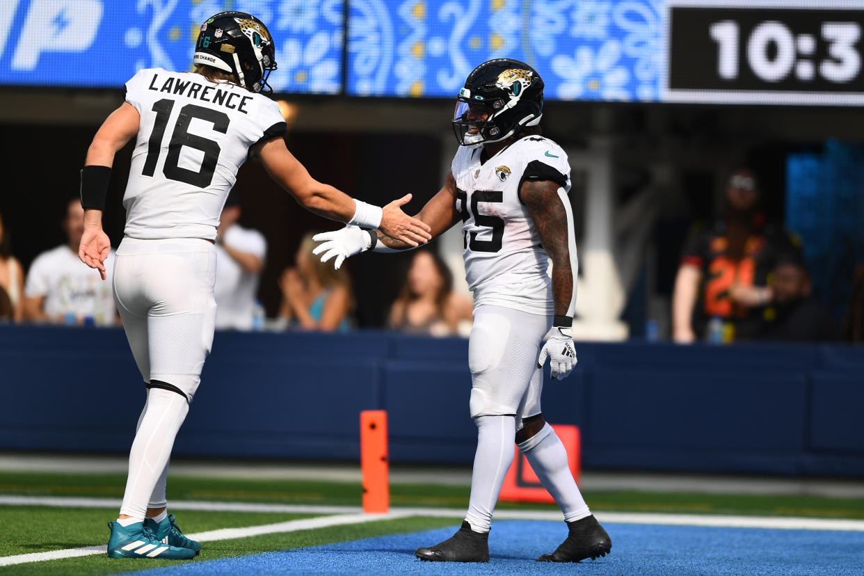Jacksonville Jaguars quarterback Trevor Lawrence (16) and running back James Robinson are seeing their fantasy values increase