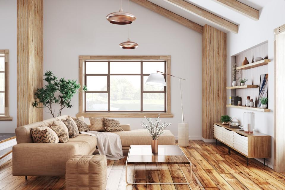 Modern interior of living room with beige sofa and wooden accents