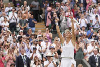 Germany's Tatjana Maria celebrates defeating Latvia's Jelena Ostapenko during a fourth round women's singles match on day seven of the Wimbledon tennis championships in London, Sunday, July 3, 2022. (AP Photo/Alberto Pezzali)