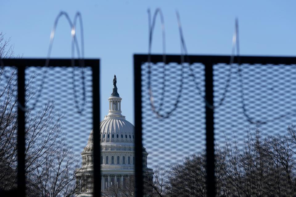 FILE - In this March 20, 2021, file photo the U.S. Capitol dome stands past partially-removed razor wire hanging from a security fence on Capitol Hill in Washington. Authorities suggested for weeks in court hearings and papers that members of the Oath Keepers militia group planned their attack on the Capitol in advance in an effort to block the peaceful transition of power. But prosecutors have since said it’s not clear whether the group was targeting the Capitol before Jan. 6, giving defense attorneys an opening to try to sow doubt in the government’s case. (AP Photo/Patrick Semansky, File) ORG XMIT: WX106