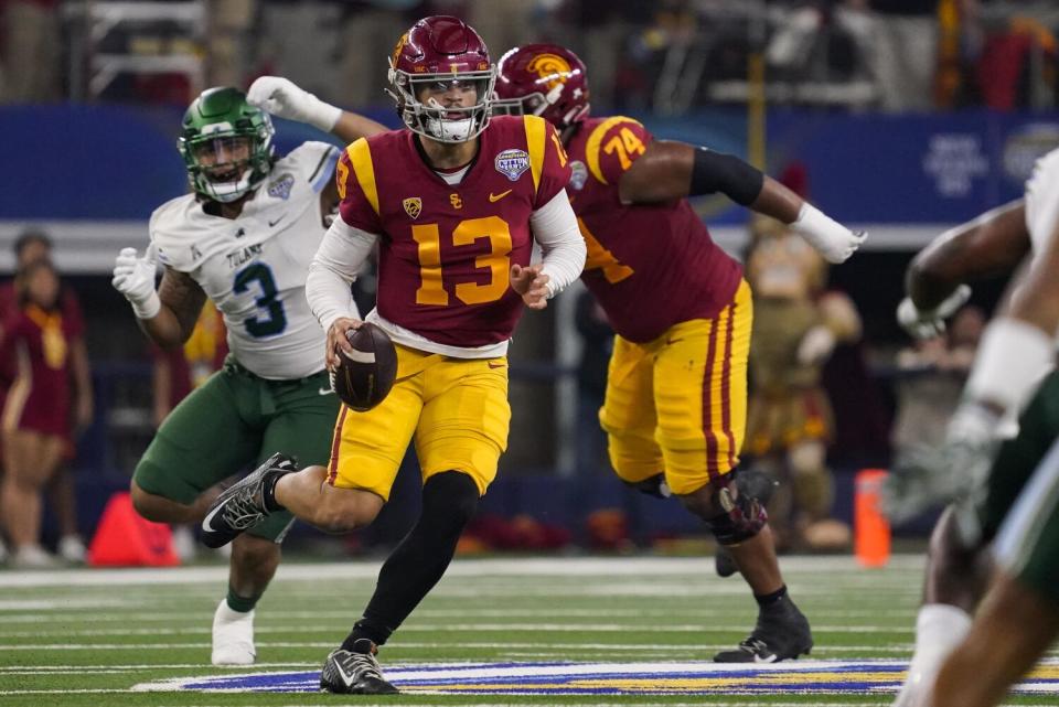 USC quarterback Caleb Williams runs with the ball during the first half.