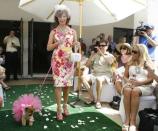 Karen Coe Donohoo of Palm Desert walks her Pomeranian BooBoo Bear, the flower boy, wearing a pink tule during a dog wedding at Palm Desert Resort Country Club Sunday April 22, 2012. The event benefits the Humane Society of the Desert. <br> (Photo courtesy Wade Byars/The Desert Sun) <br> <br> (Originally reported in <a href="http://www.mydesert.com/article/20120423/NEWS01/204230322/Wedded-bliss-gone-dogs?odyssey=tab|topnews|text|Frontpage" rel="nofollow noopener" target="_blank" data-ylk="slk:The Desert Sun;elm:context_link;itc:0;sec:content-canvas" class="link ">The Desert Sun</a>)