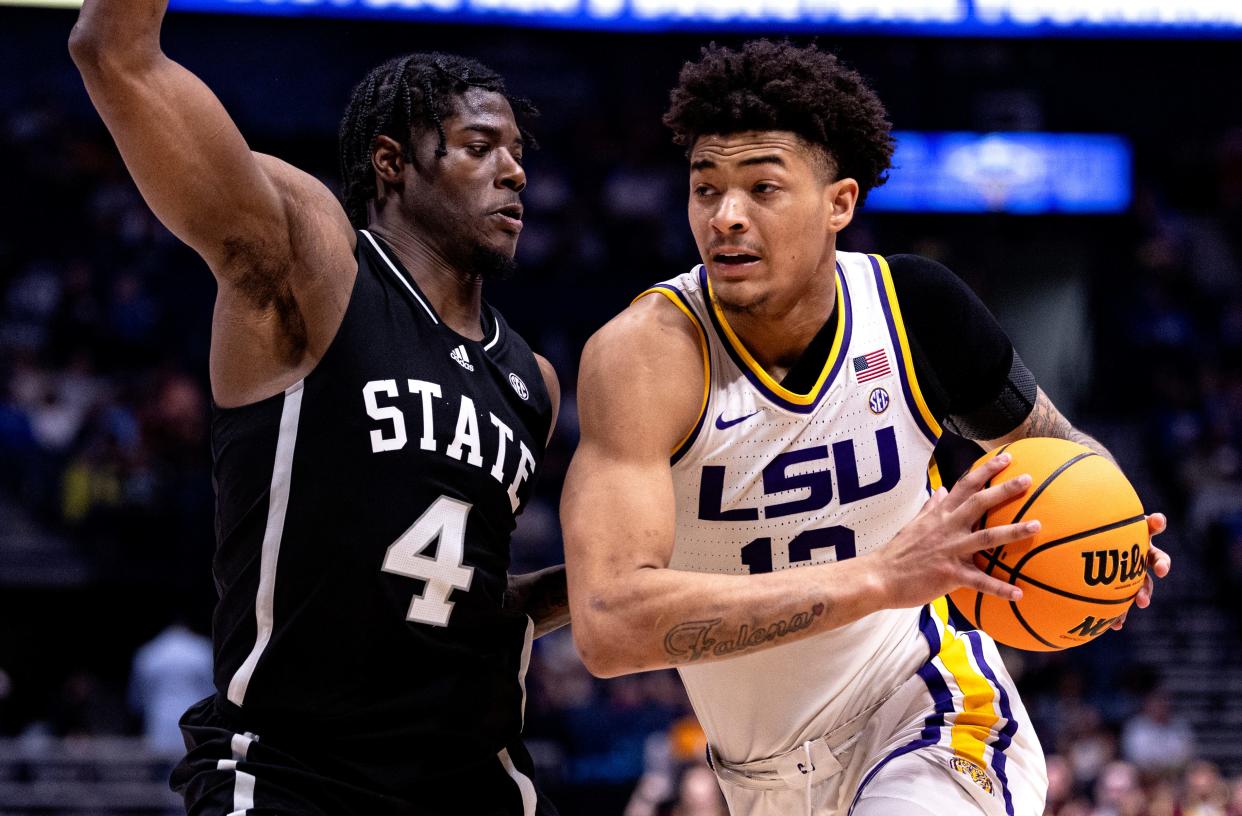 Mar 14; Nashville, Tennessee, United States; LSU forward Jalen Reed (13) drives as hÕes defended by Mississippi State forward Cameron Matthews (4)during a MenÕs SEC Tournament game at Bridgestone Arena in Nashville, Tennessee.