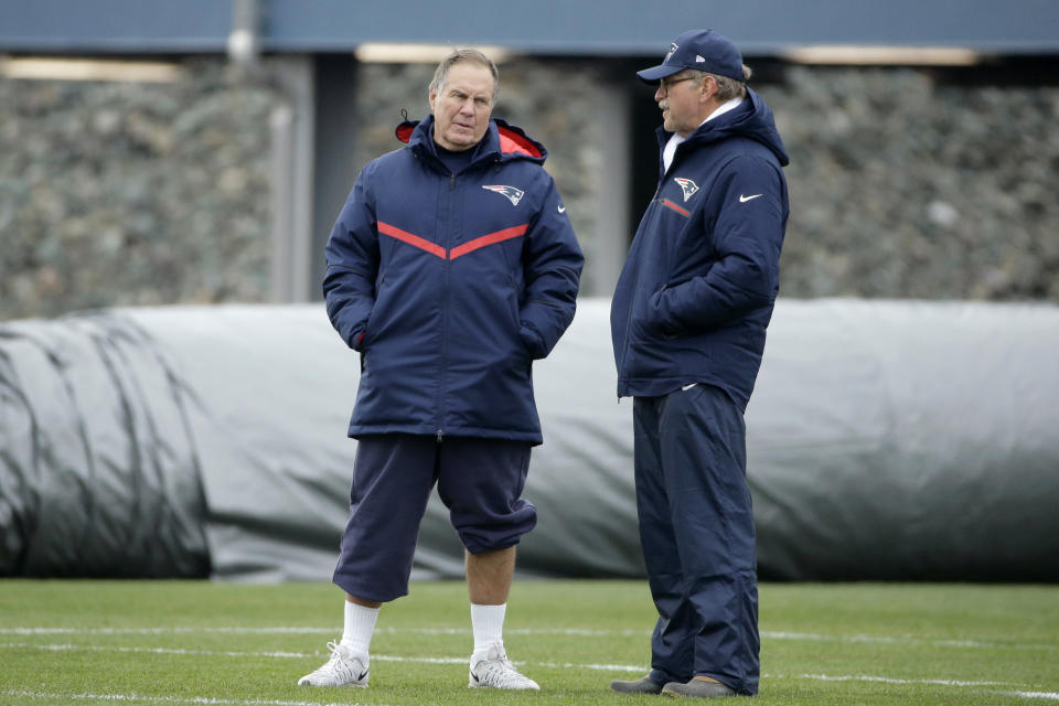 FILE — New England Patriots head coach Bill Belichick, left, speaks with football research director Ernie Adams, right, during an NFL football team practice, in this Wednesday, Dec. 7, 2016 file photo, in Foxborough, Mass. Adams, a former high school classmate of Belichick, participated in his final practice with the team Wednesday, June 16, 2021. Adams retired from his job at the Patriots, Wednesday, June 16, after 21 years with the team. (AP Photo/Steven Senne, File)