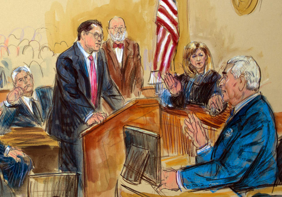 This courtroom sketch shows former campaign adviser for President Donald Trump, Roger Stone talking from the witness stand as prosecution attorney Jonathan Kravis, standing left, Stone's attorney Bruce Rogow, third from right, and Judge Amy Berman Jackson listen, during a court hearing at the U.S. District Courthouse in Washington, Thursday, Feb. 21, 2019. Berman Jackson issued a broad gag order forbidding Stone to discuss his criminal case with anyone and gave him a stinging reprimand over his posting of a photo of the judge with what appeared to be crosshairs of a gun. (Dana Verkouteren via AP)