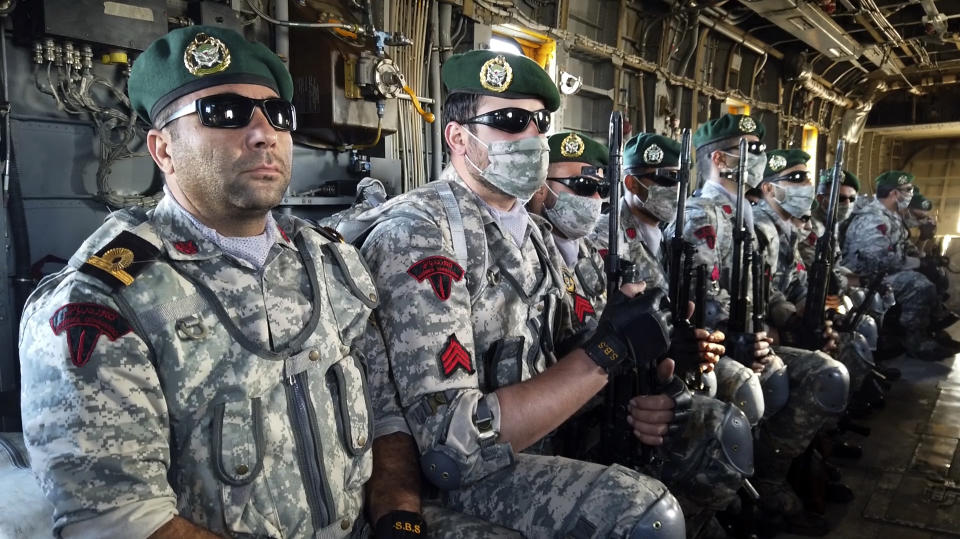 This image made from a video released on Wednesday, Jan. 13, 2021, by the Iranian Army shows troops sitting in a helicopter during a navy drill. Iran's navy began a short-range missile drill in the Gulf of Oman on Wednesday, state TV reported, amid heightened regional tensions over Tehran's nuclear program and a U.S. pressure campaign against the Islamic Republic. (Iranian Army via AP)