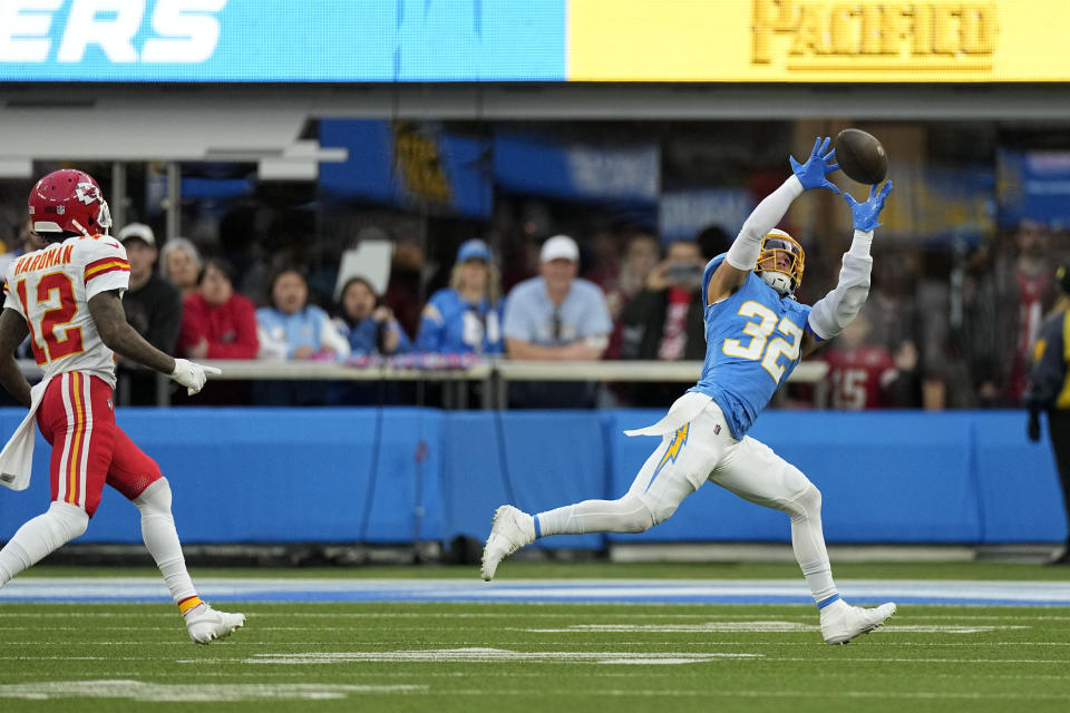 Los Angeles Chargers safety Alohi Gilman (32) intercepts a pass intended for Kansas City Chiefs wide receiver Mecole Hardman Jr., left, during the first half of an NFL football game, Sunday, Jan. 7, 2024, in Inglewood, Calif. (AP Photo/Mark J. Terrill)