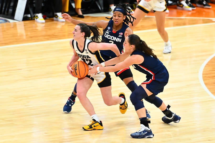 CLEVELAND, OHIO – APRIL 05: Caitlin Clark #22 of the Iowa Hawkeyes is fouled by <a class="link " href="https://sports.yahoo.com/wnba/players/10160/" data-i13n="sec:content-canvas;subsec:anchor_text;elm:context_link" data-ylk="slk:Nika Muhl;sec:content-canvas;subsec:anchor_text;elm:context_link;itc:0">Nika Muhl</a> #10 of the UConn Huskies in the second half during the NCAA Women’s Basketball Tournament Final Four semifinal game at Rocket Mortgage Fieldhouse on April 05, 2024 in Cleveland, Ohio. Iowa defeated Connecticut 71-69 (Photo by Jason Miller/Getty Images)